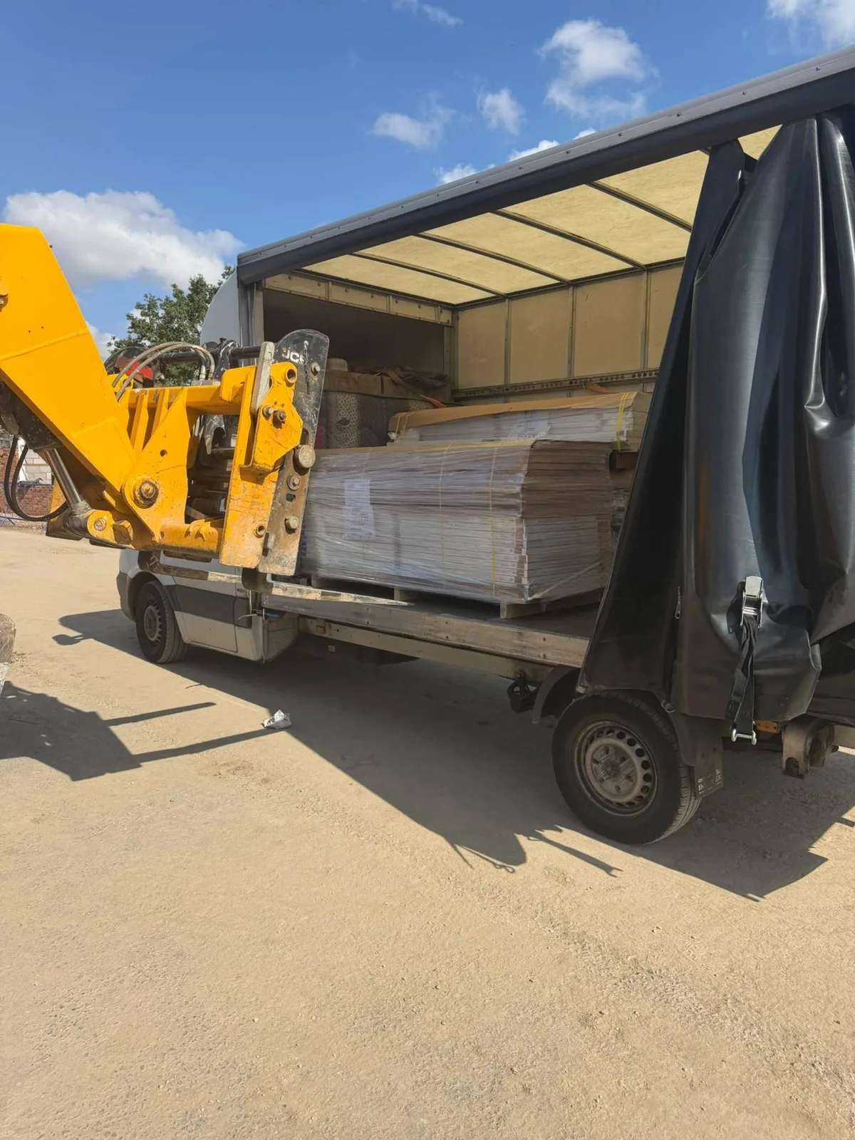 Palletised door kits collected in the West Midlands loaded on a curtain side vehicle for delivery to a housebuilder client