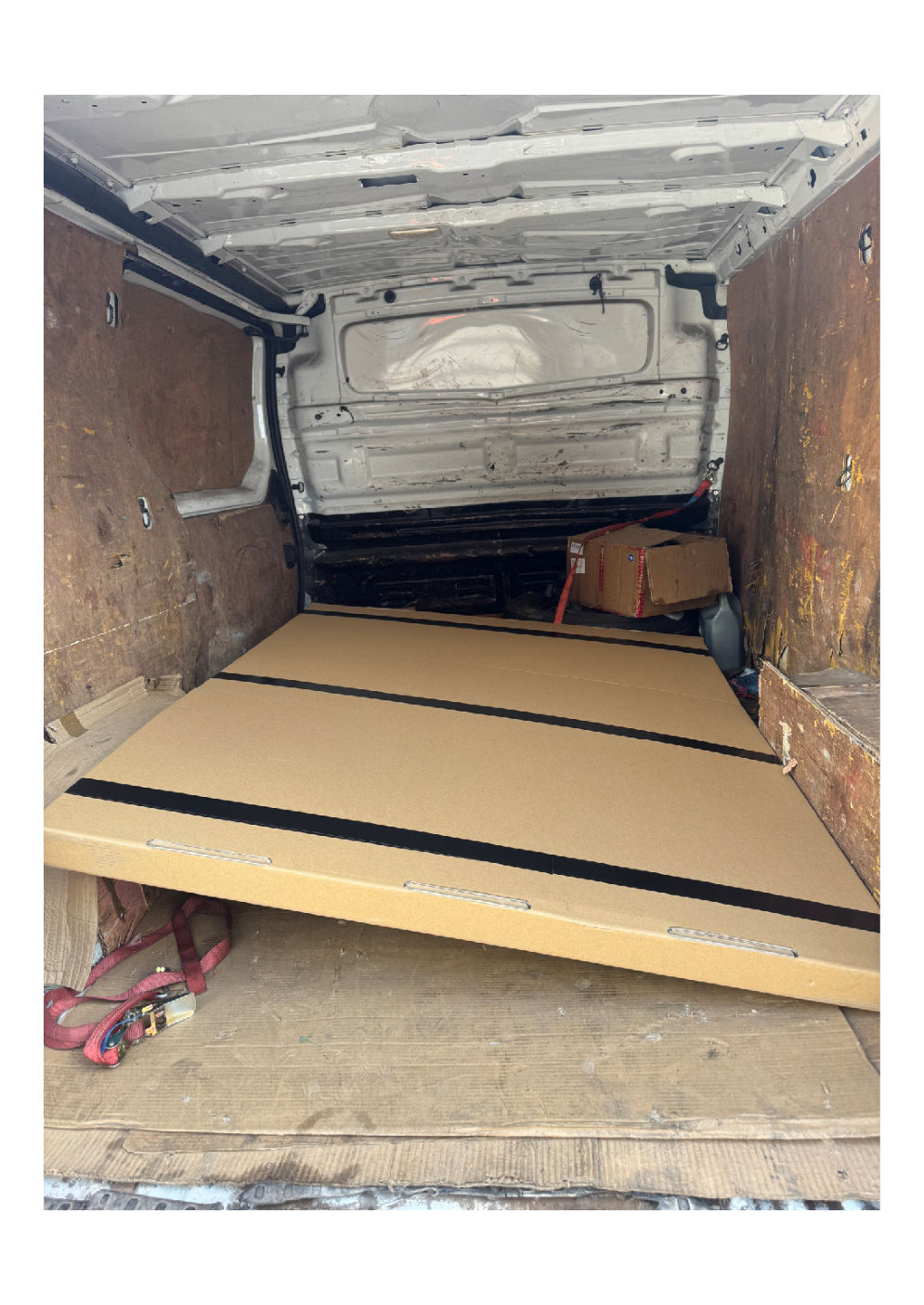 flat packed goods and boxes strapped securely inside a white cargo van ready for a full day retail delivery