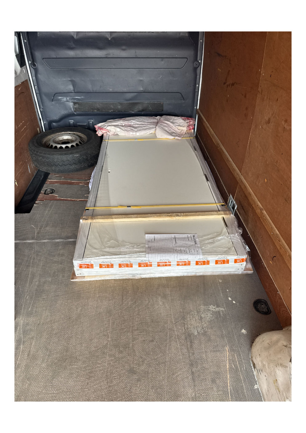 flat packed white panels loaded inside a cargo van in Birmingham for regional site delivery