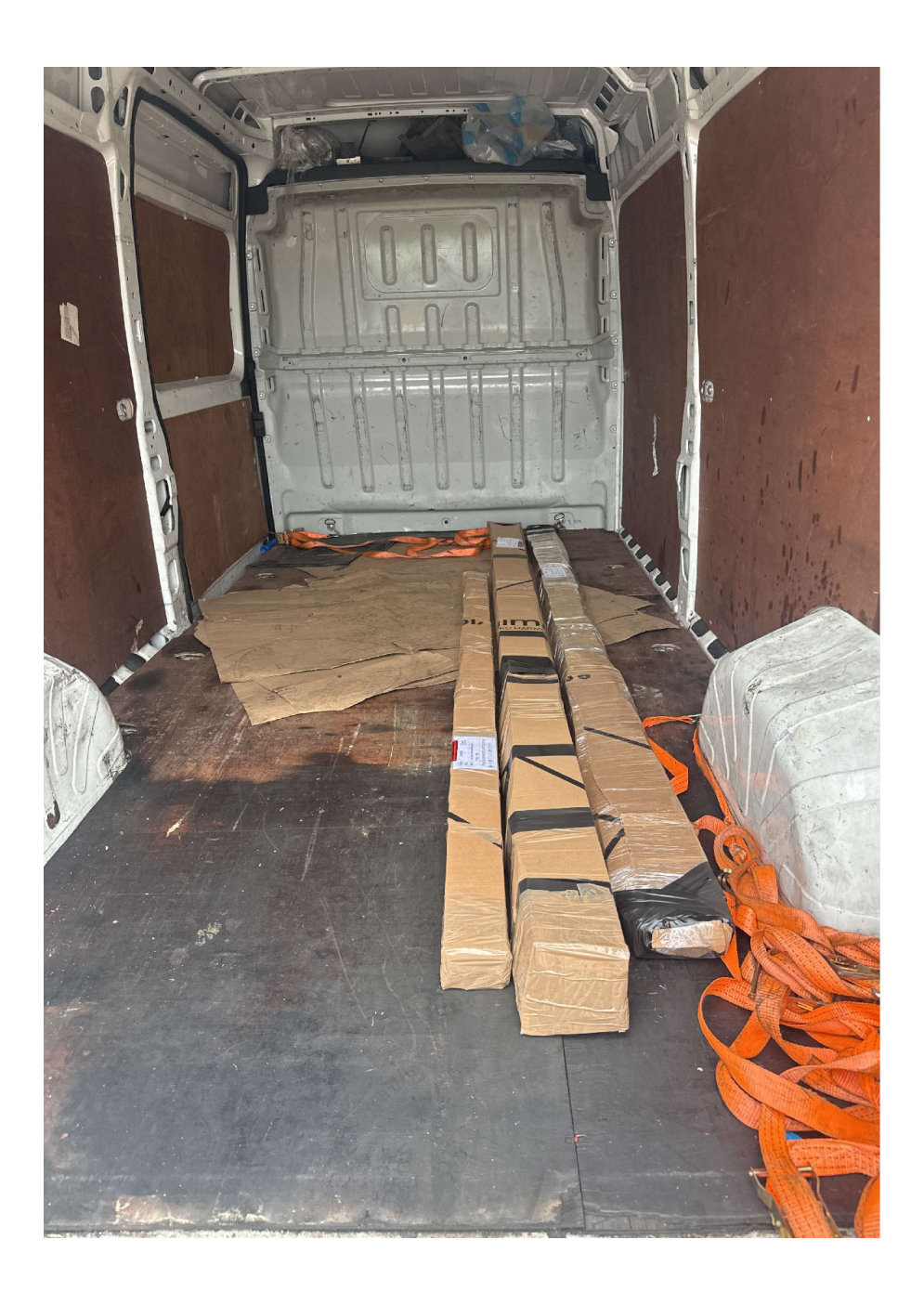 PEFC certified timber joinery packages secured with tie down straps in a van ready for same day delivery across London